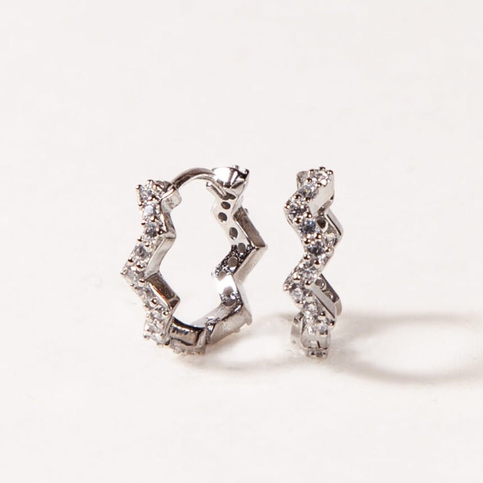 Pair of silver hoop earrings on a white background