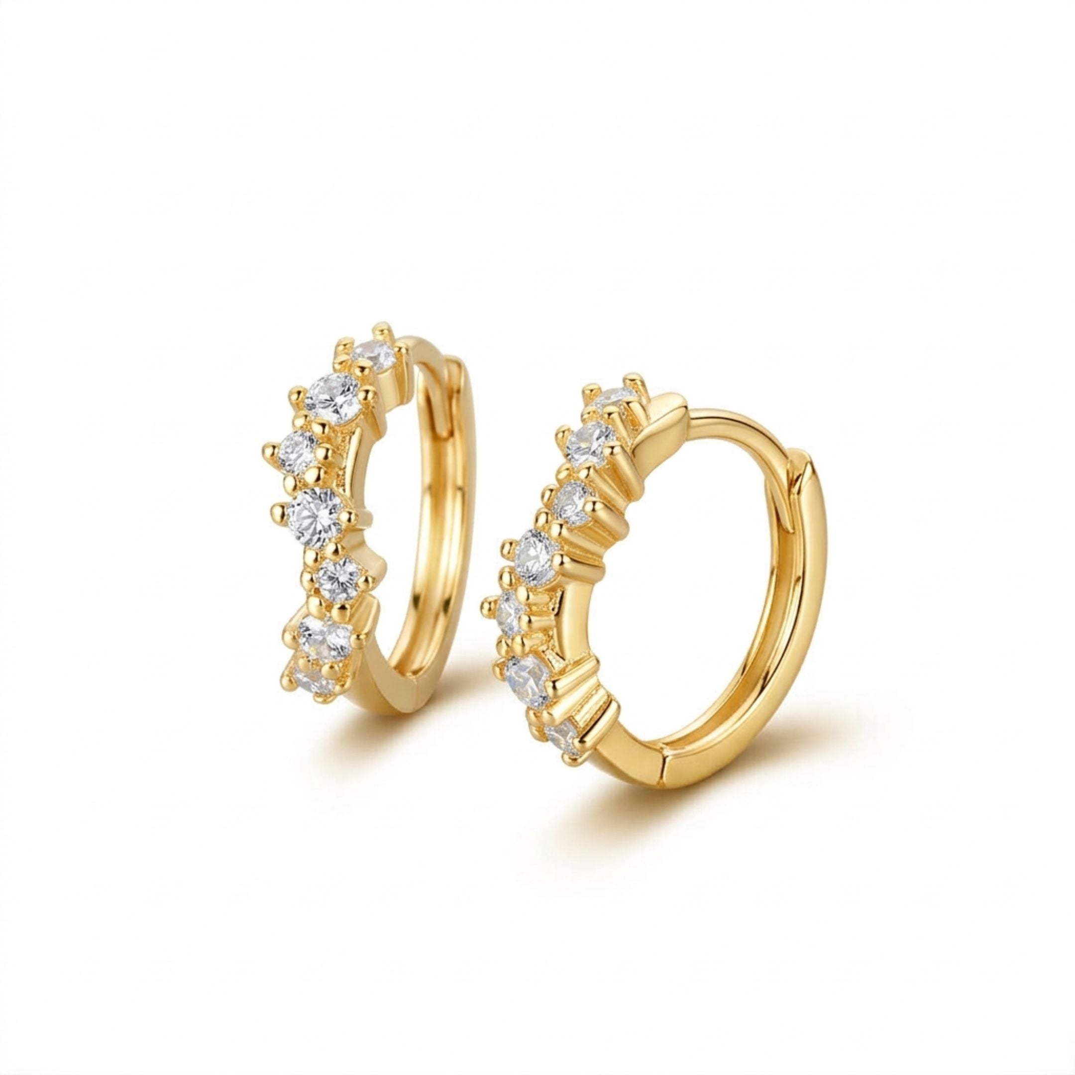 Gold hoop earrings with embedded diamonds on a white background