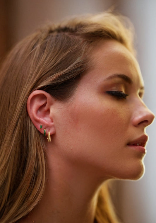 Close-up of a woman's profile with focus on her earrings.