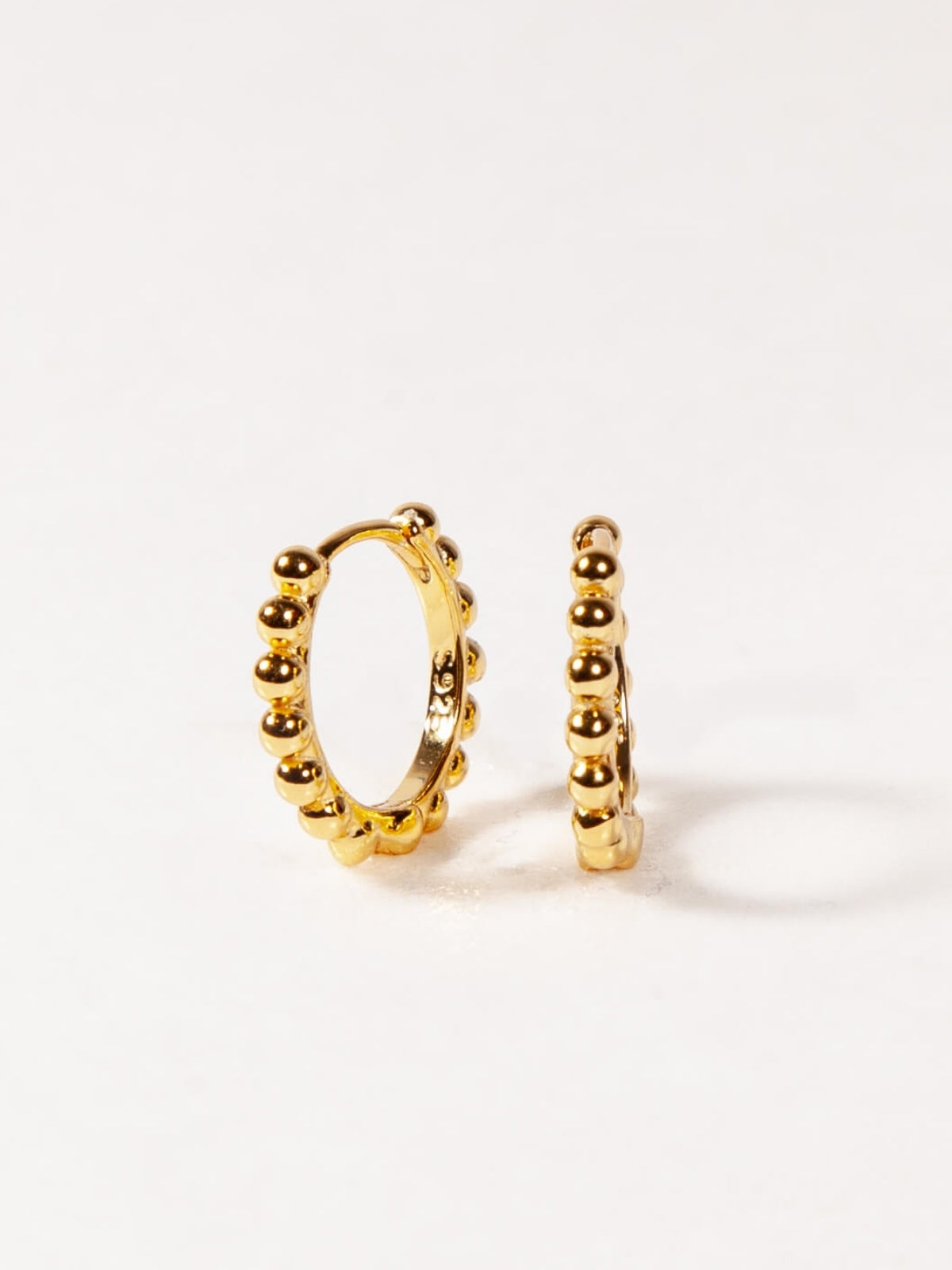Gold hoop earrings on a white background
