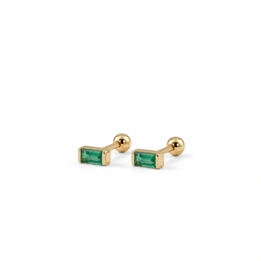 A pair of gold barbell stud earrings with rectangular green emerald-cut gemstones, displayed on a clean white background.