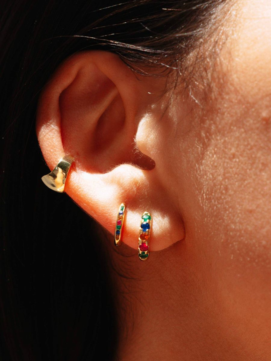 Close up of an ear with colorful hoops