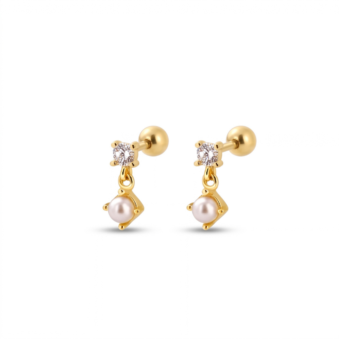 A pair of gold-plated studs with a small clear round-cut gemstone and a dangling pink pearl in a bezel setting, shown on a plain white background.