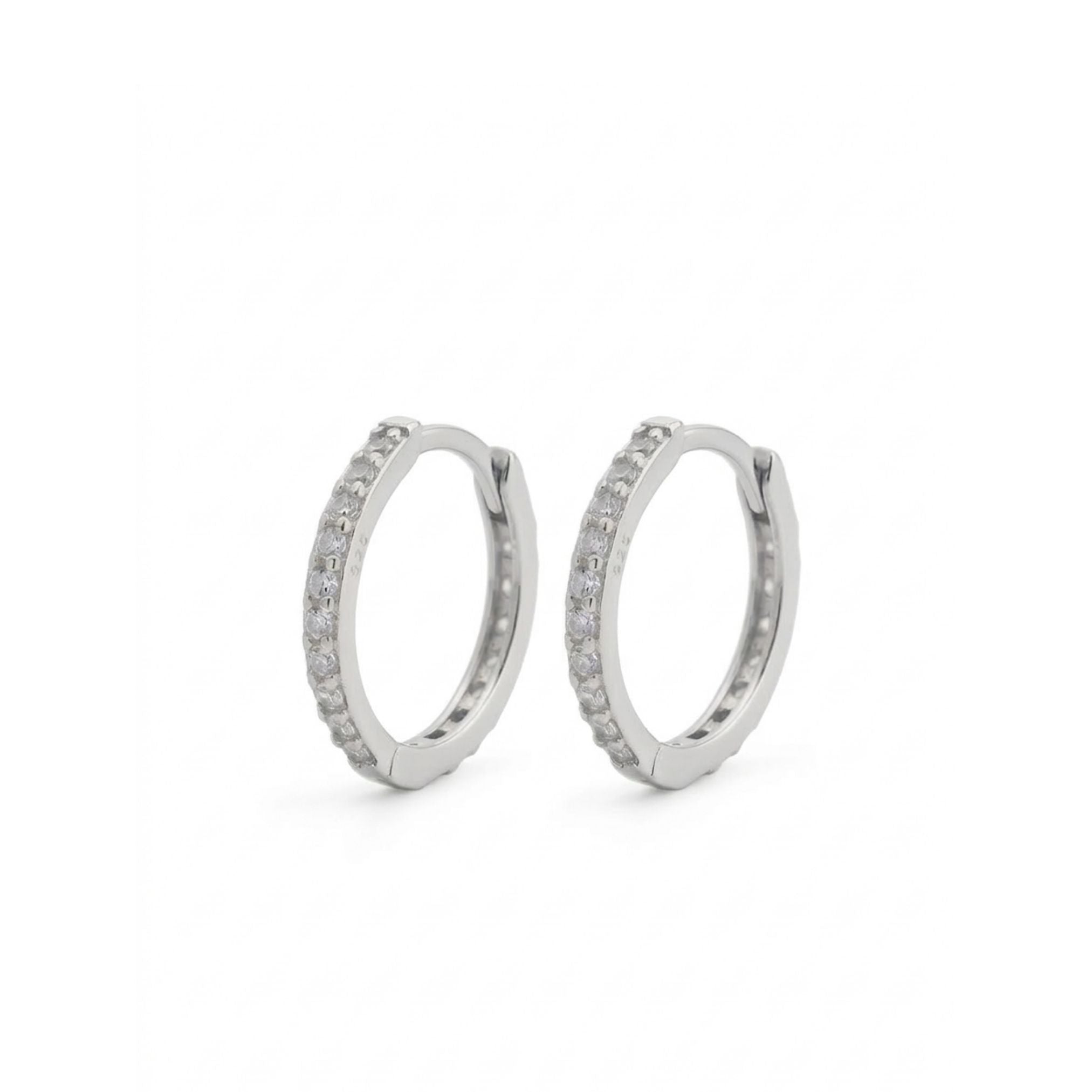 Pair of silver hoop earrings with embedded stones on a white background