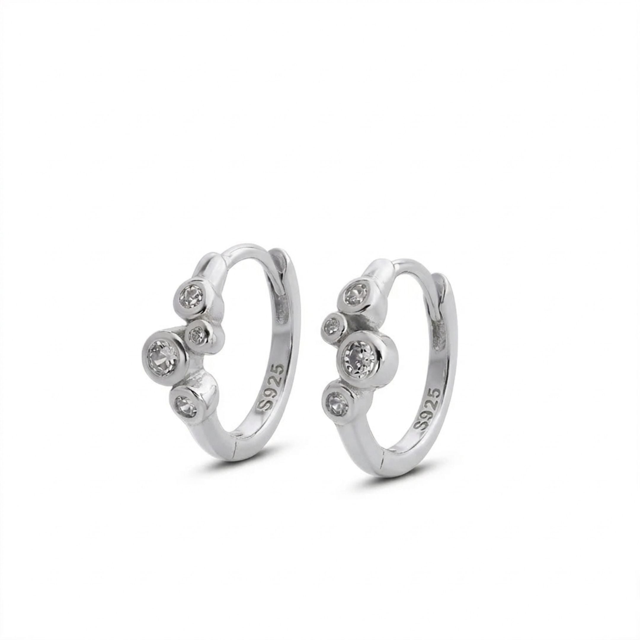Pair of silver hoop earrings with small gemstones on a white background