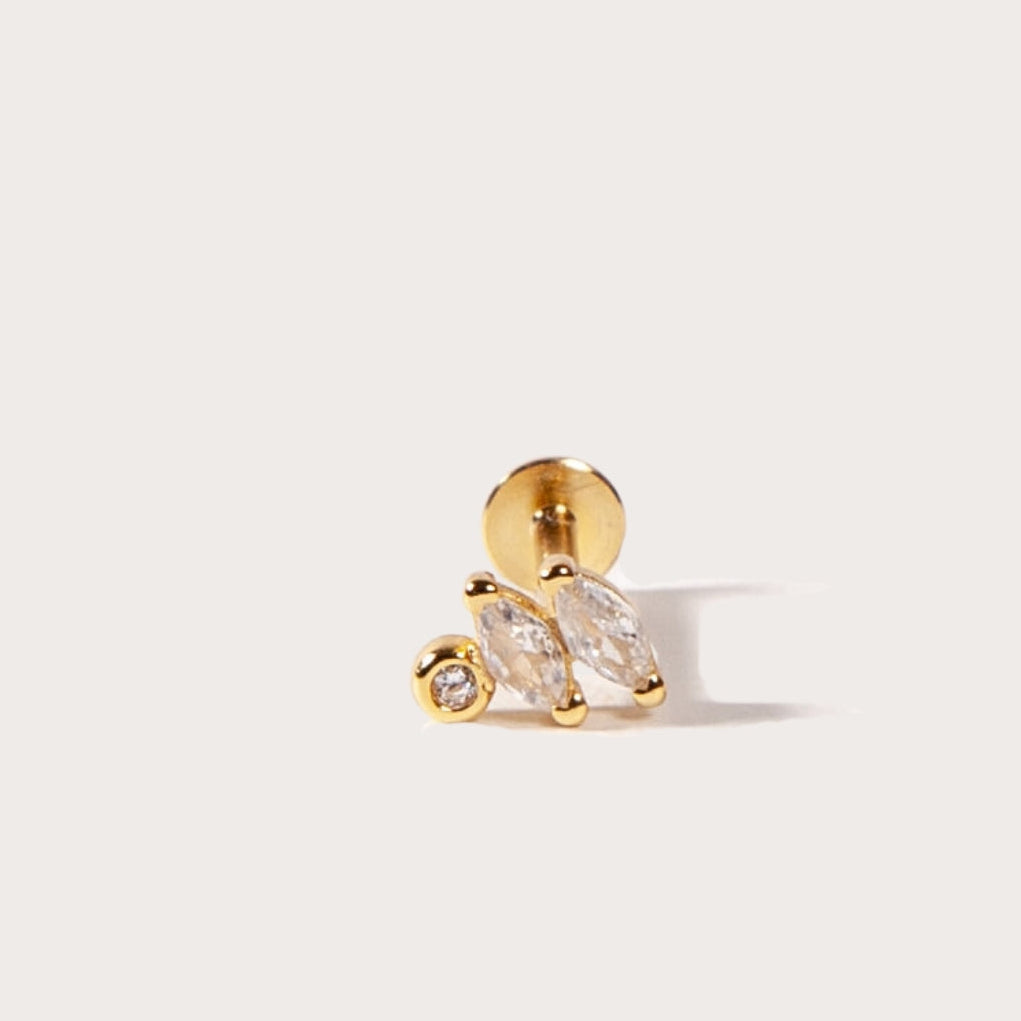 Gold earring with a clear CZ stones on a light gray background