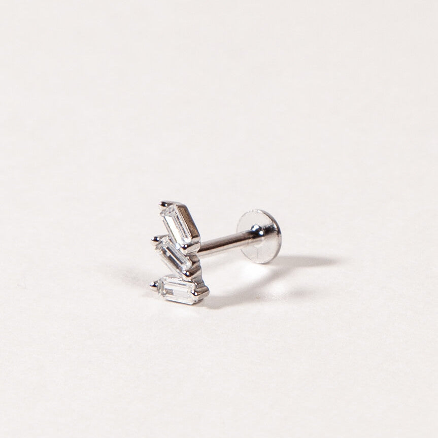 Silver Triple baguette CZ earring on a light gray background