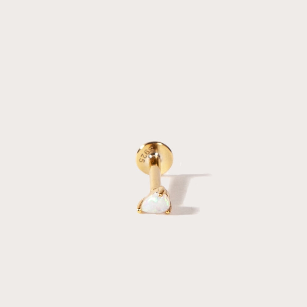 Gold and opal pear shape flatback on a light beige background