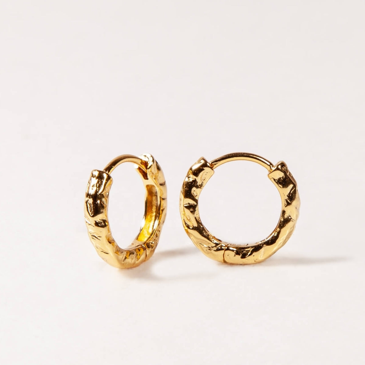 Gold hoop earrings on a white background