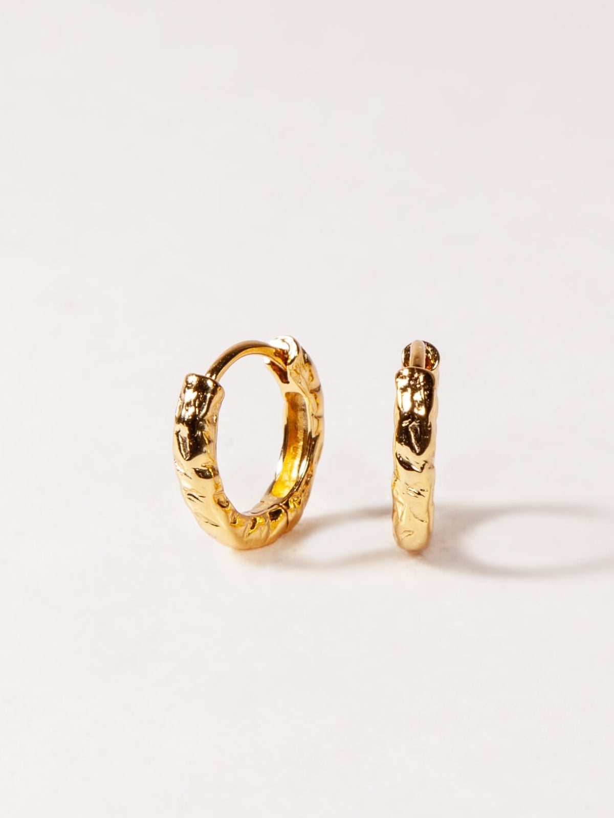 Gold hoop earrings on a white background