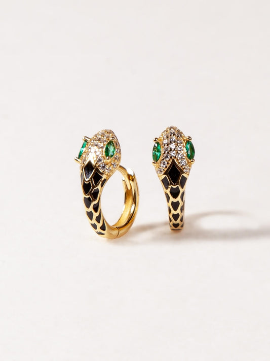 Pair of gold earrings with green gemstones on a white background
