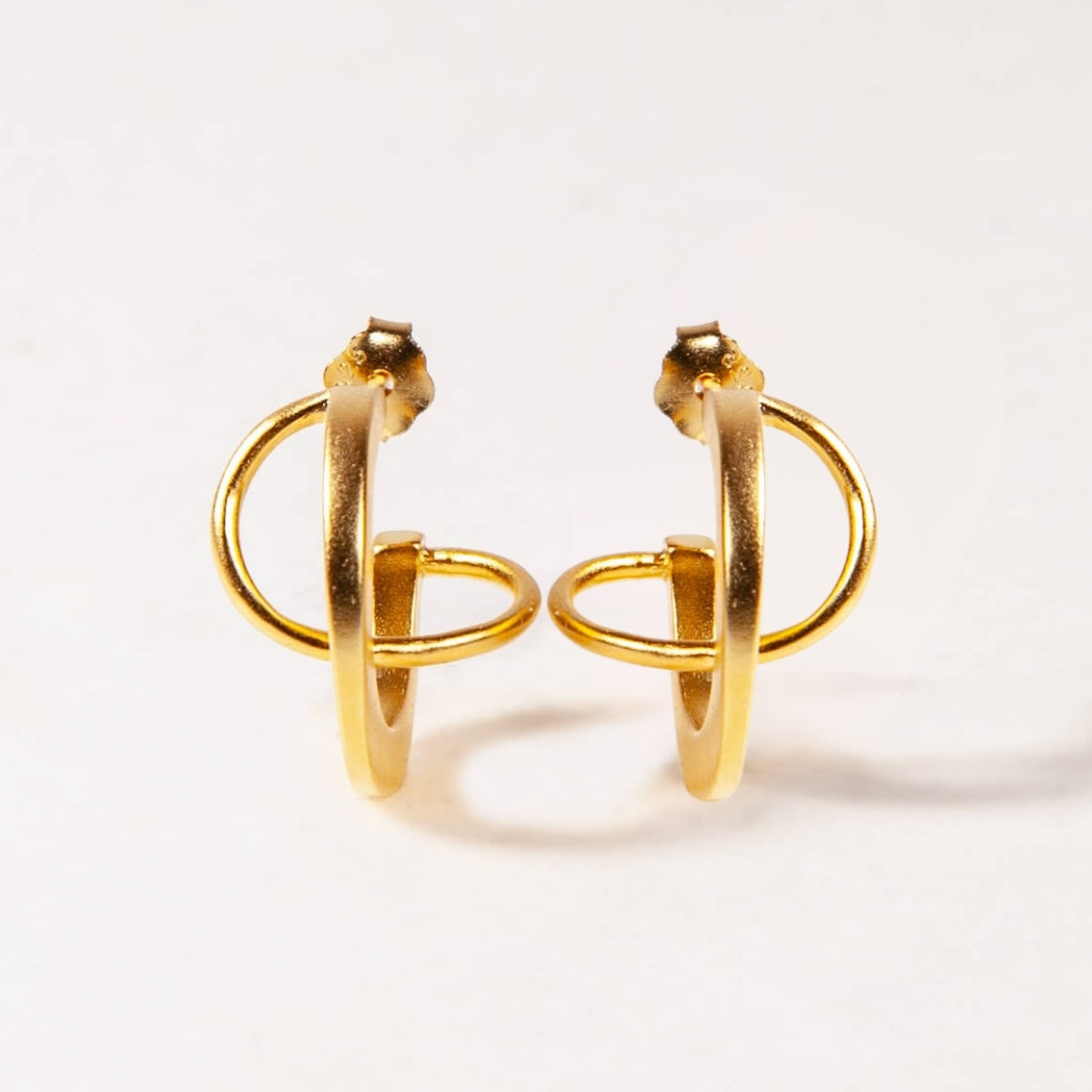 Pair of gold hoop earrings on a white background