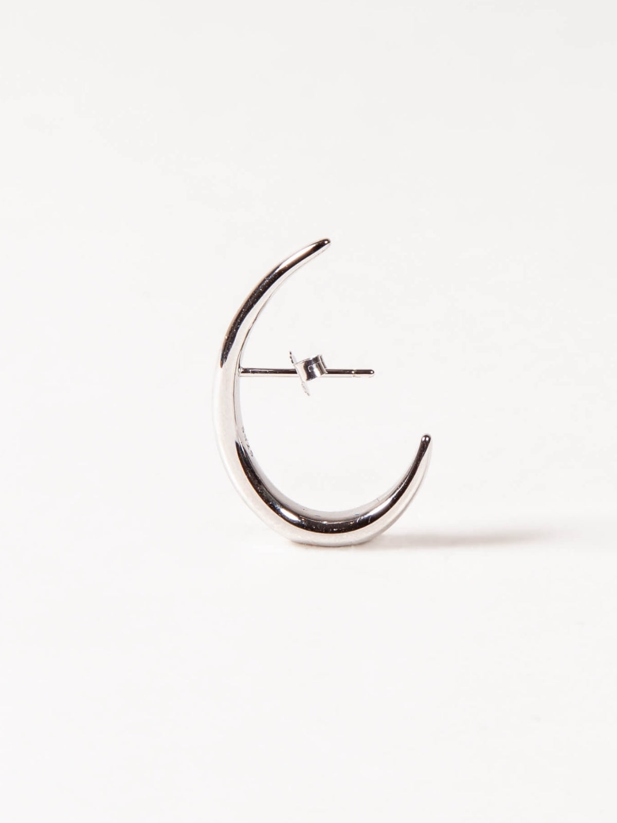 Silver hoop earring on a white background