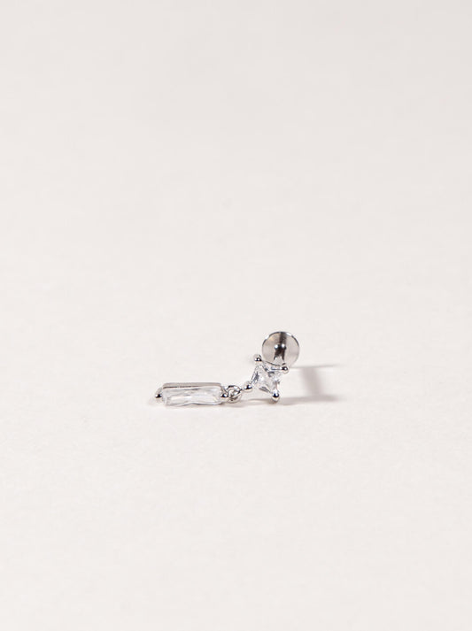 Silver earring with a clear cz on a light gray background