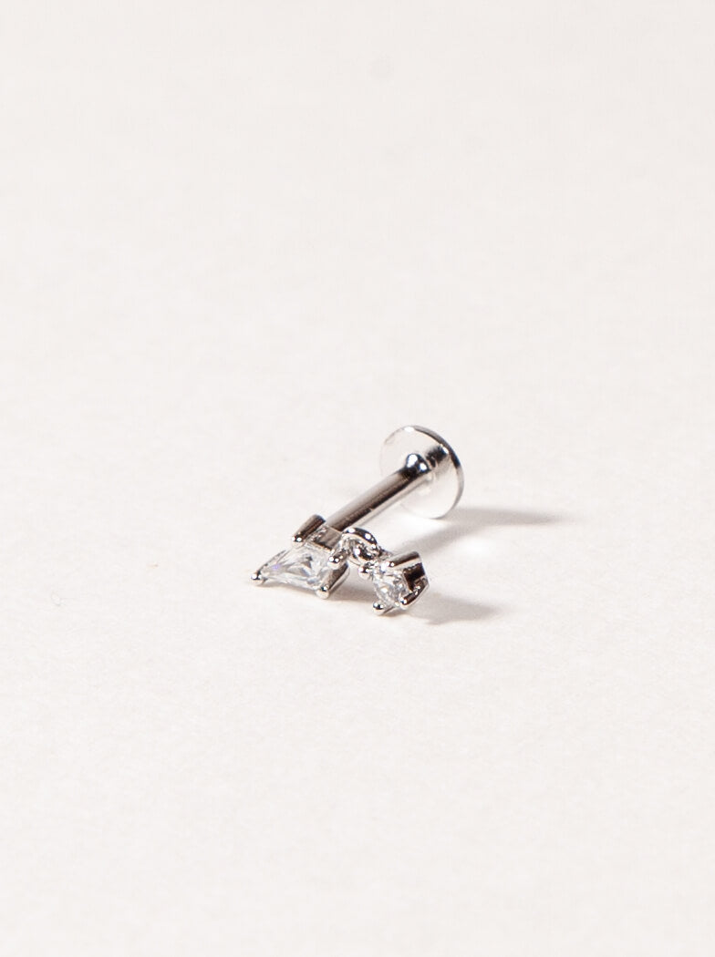 Silver earring with clear CZ on a light gray background