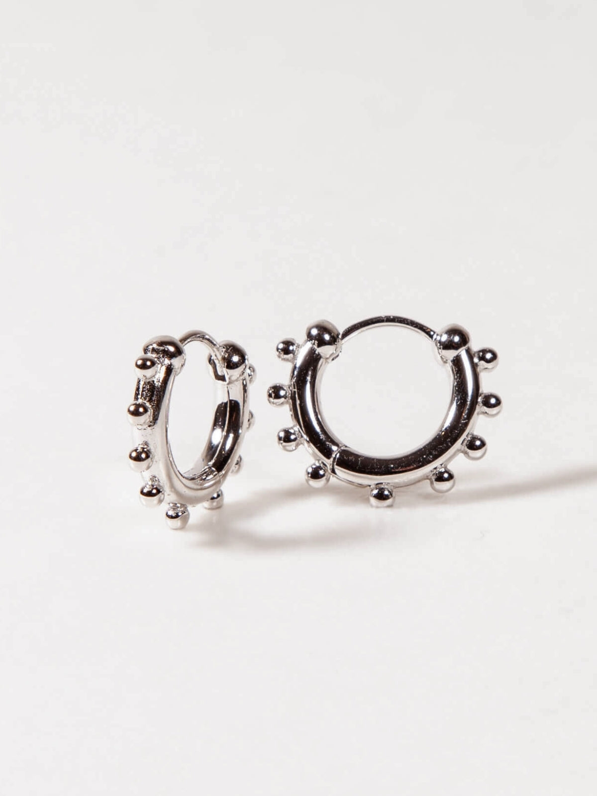 Silver hoop earrings on a white background