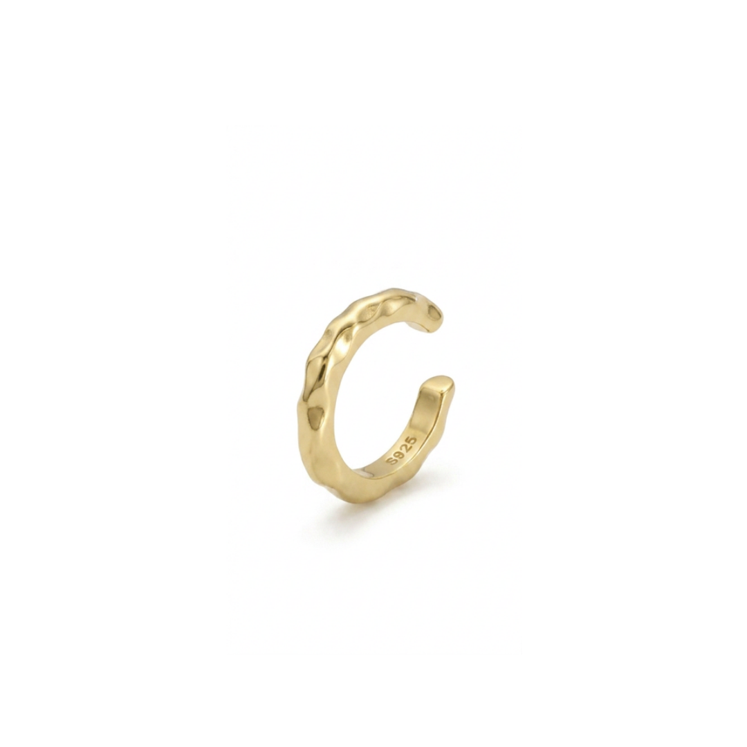 A textured gold ear cuff, shown on a clean white background with a soft shadow.