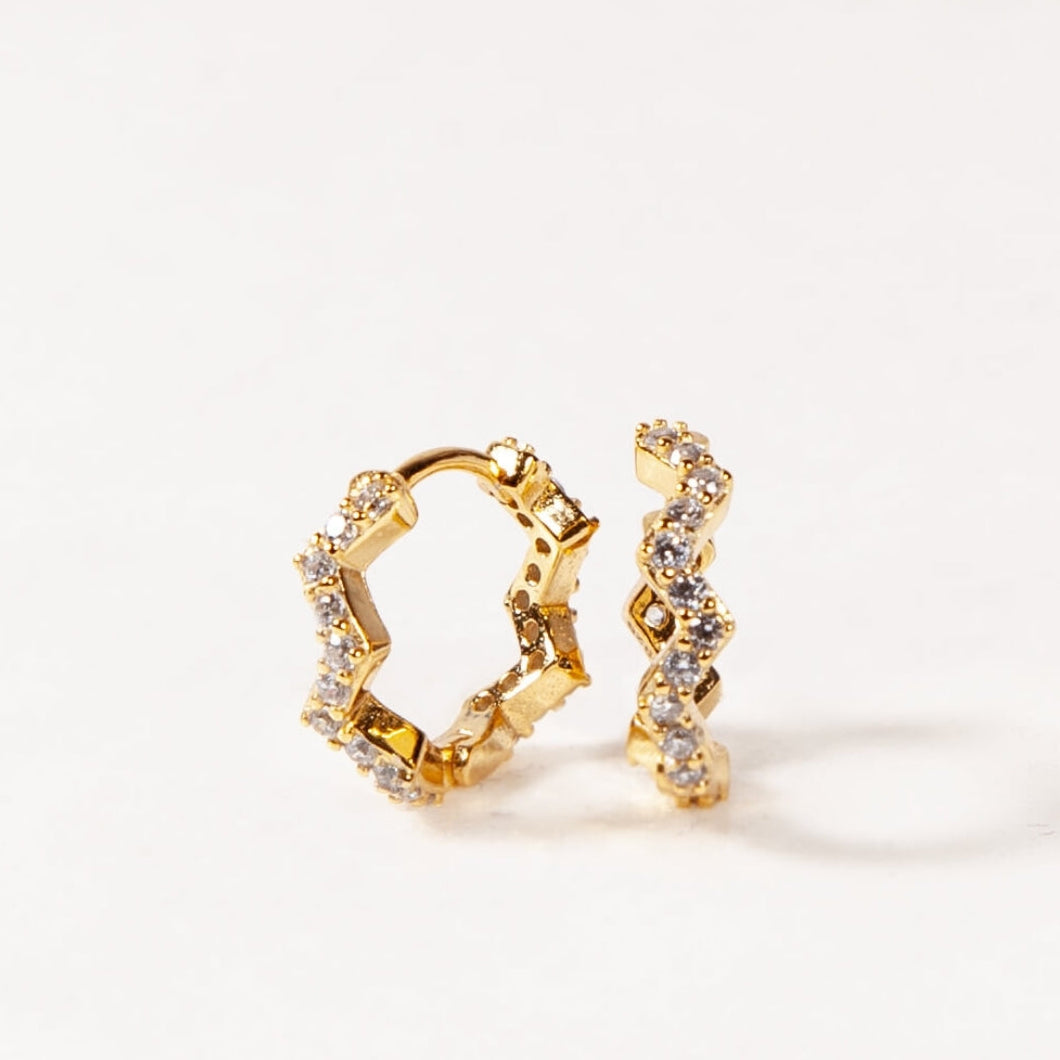 Gold hoop earrings with diamond accents on a white background