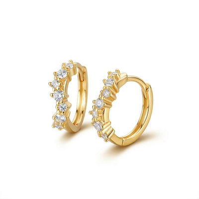 Gold hoop earrings with embedded diamonds on a white background