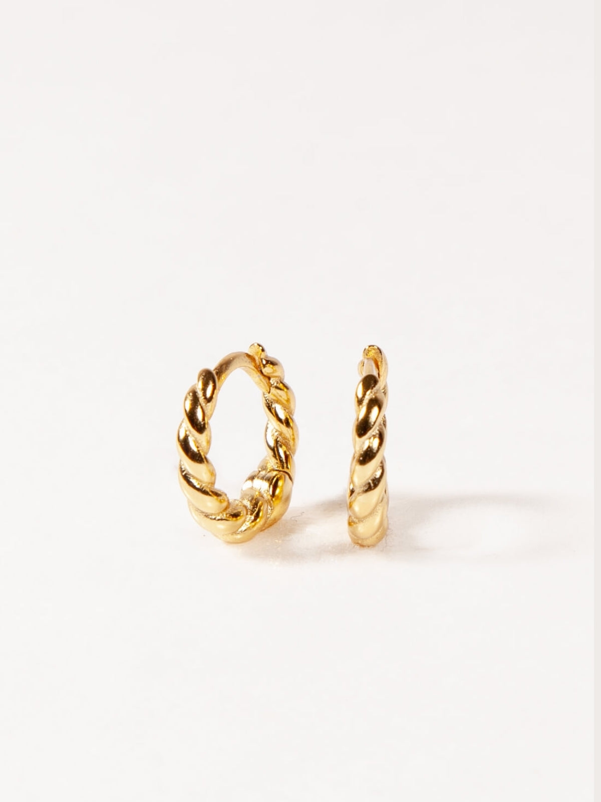 Pair of gold hoop earrings on a white background
