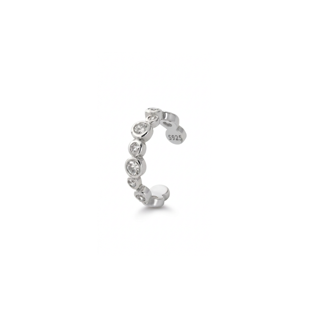 A delicate ear cuff adorned with a row of clear round-cut cz, shown on a plain white background. The inner band is stamped with 'S925', indicating sterling silver purity.