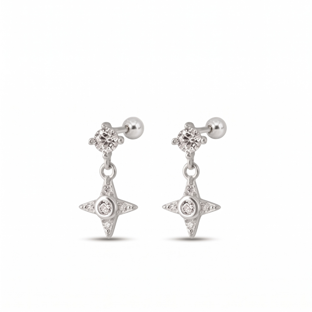 A pair of silver-toned dangle stud earrings featuring a small cluster of clear stones at the top, a drop chain, and a four-pointed star charm with a central clear stone, shown on a plain white background.
