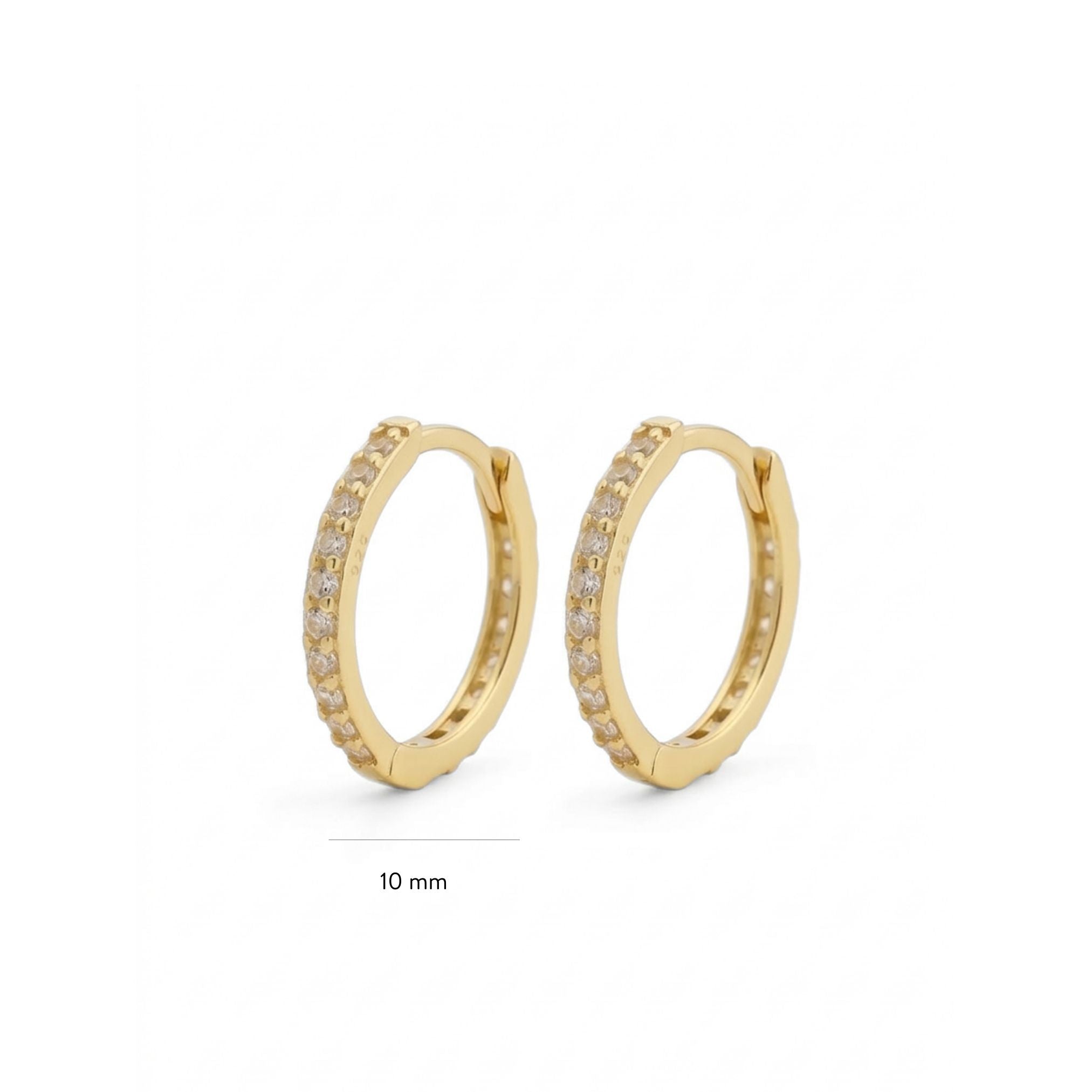 Gold hoop earrings with small cz diamonds on a white background