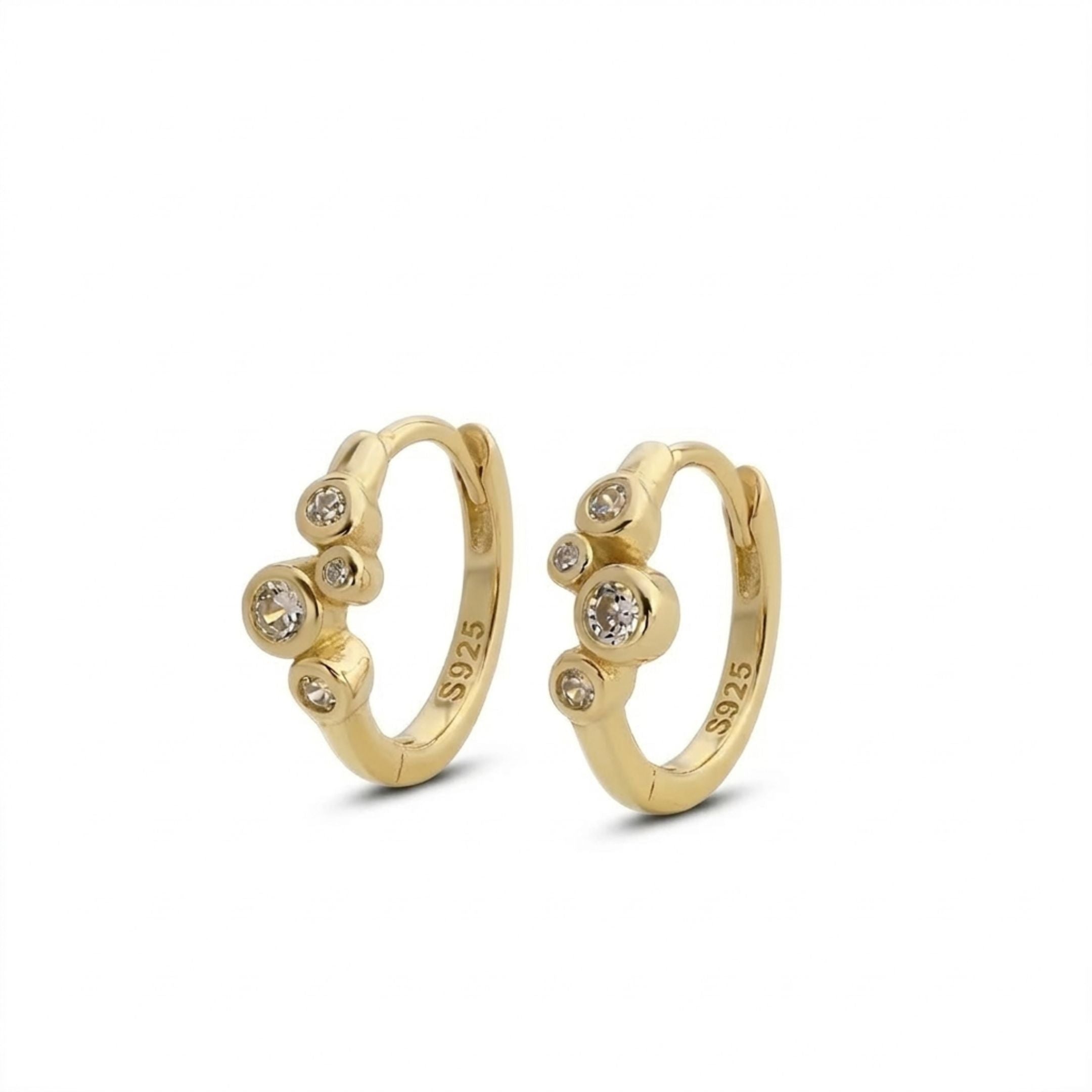 Gold hoop earrings with embedded stones on a white background