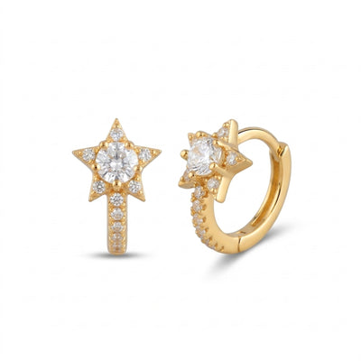 Gold star-shaped earring and hoop earring on a white background