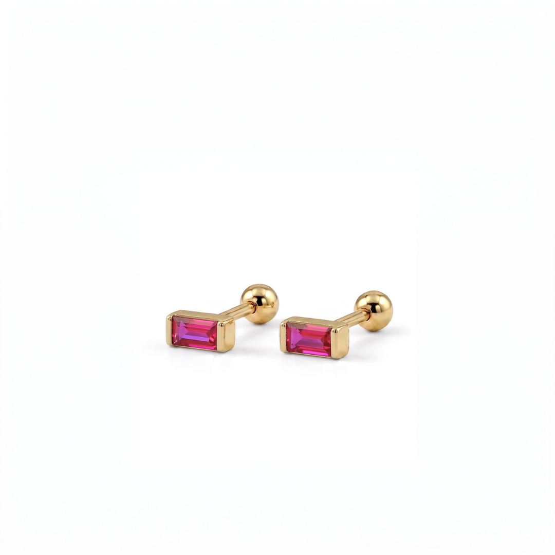 A pair of gold stud earrings with rectangular pink gemstones, shown on a clean white background.