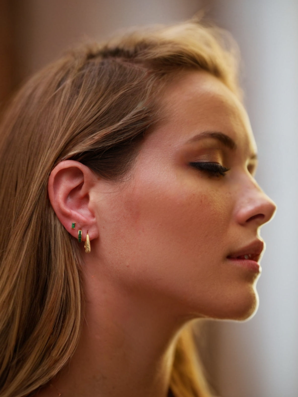 Close-up of a woman's profile with focus on her earrings.