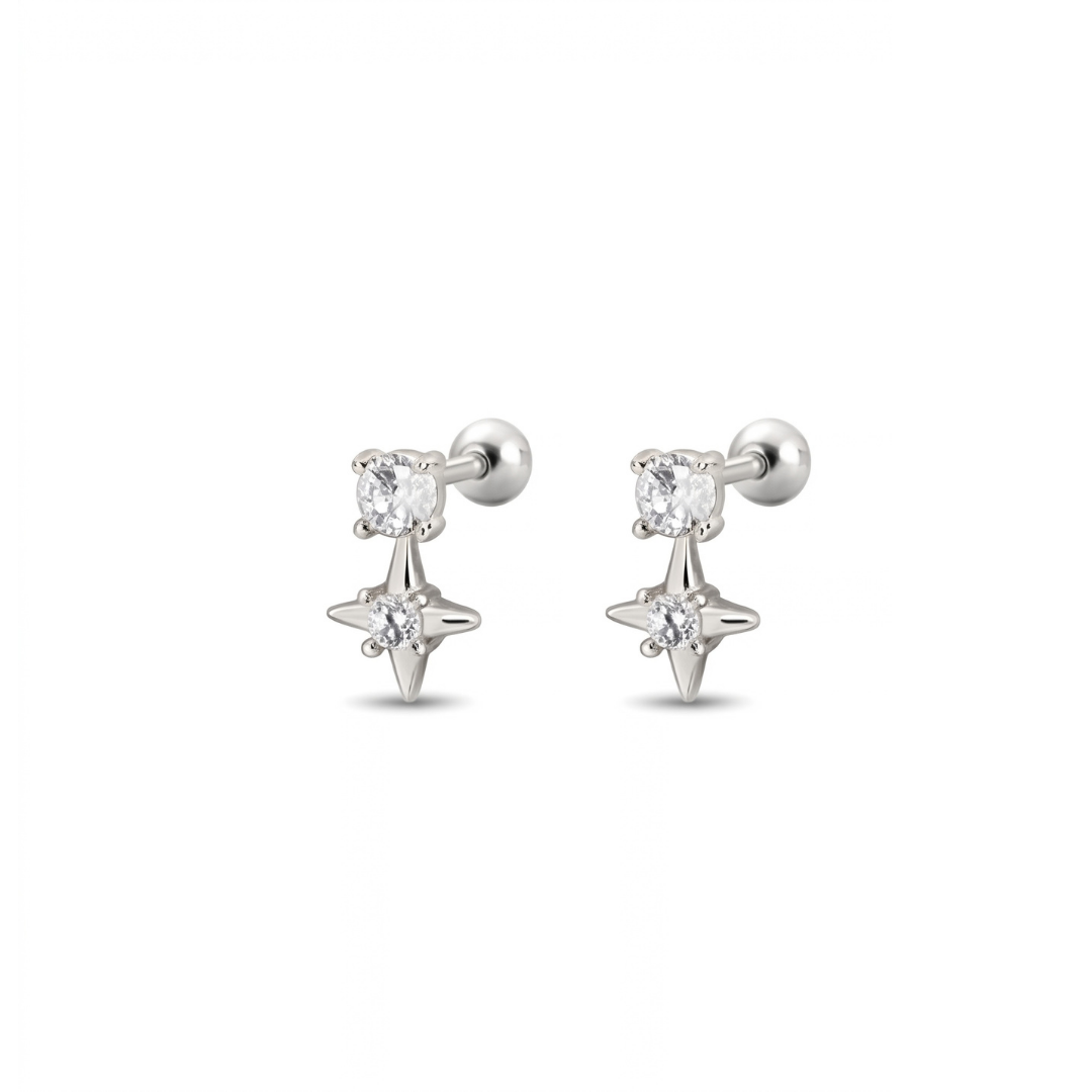 A pair of silver stud earrings featuring a round-cut clear cz and a dangling four-pointed star charm, set against a plain white background.