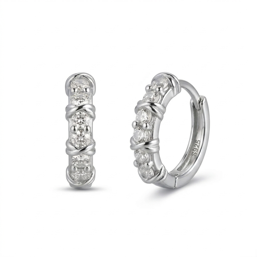 Pair of silver hoop earrings with embedded stones on a white background