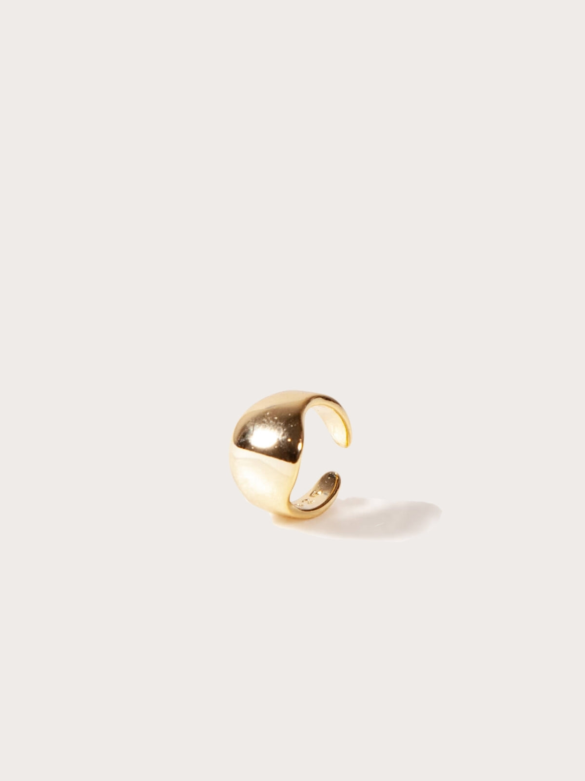 Gold cuff on a light gray background