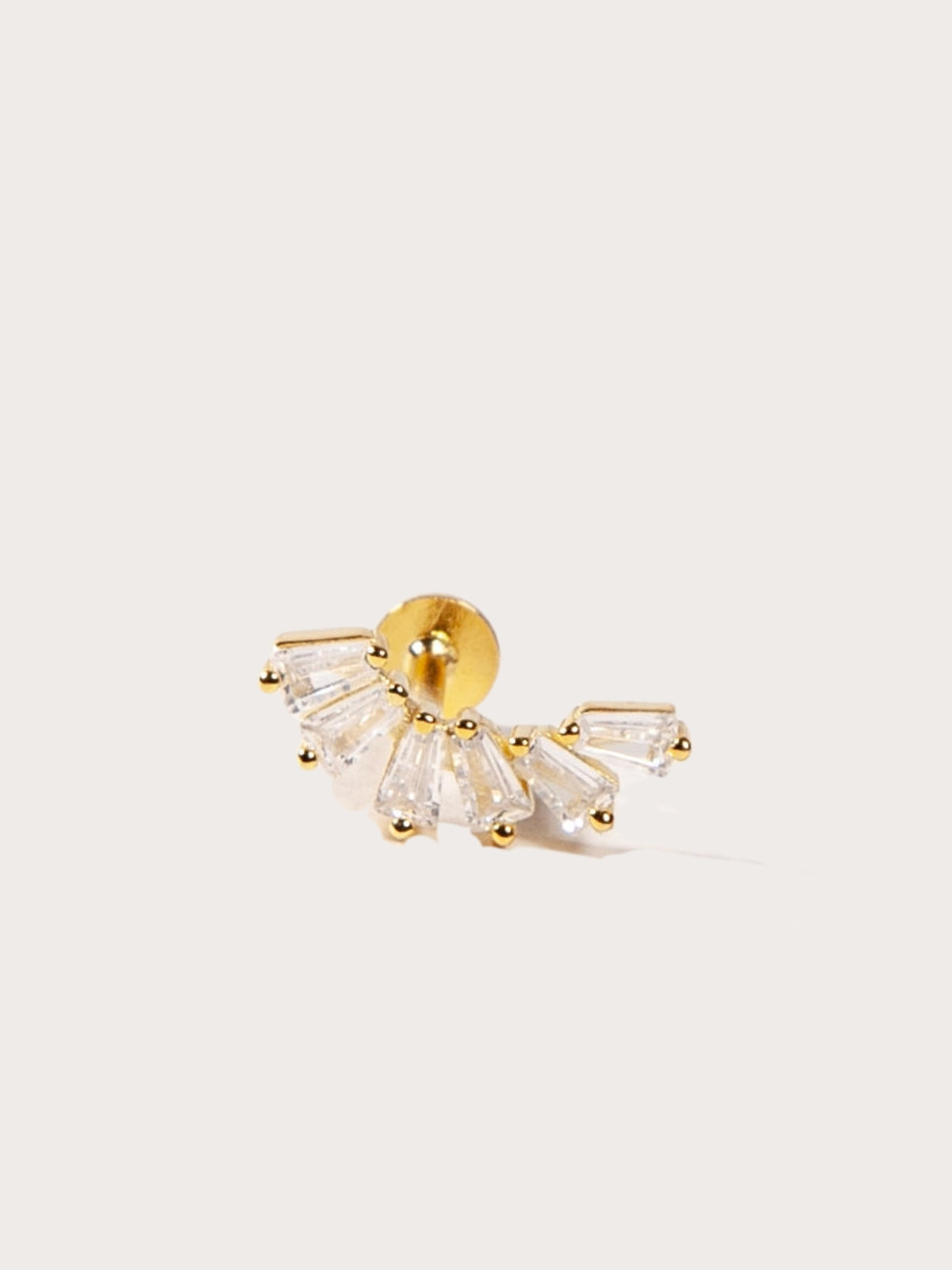 crown-like shape with baguette-cut stones stud in light background