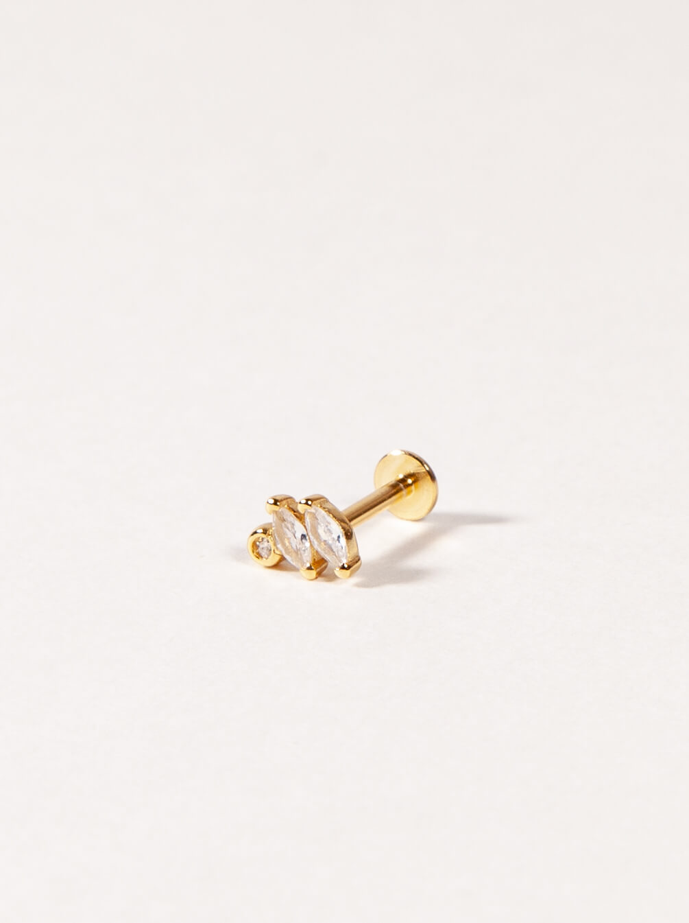 Gold Marquise cut CZ stud earring with a clear gemstone on a light gray background