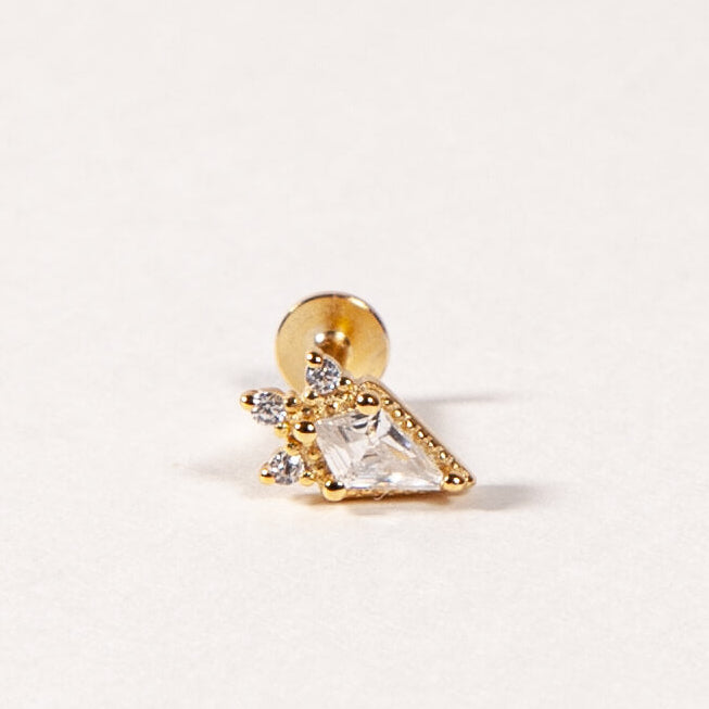 kite shape gold flatback stud on a light beige background