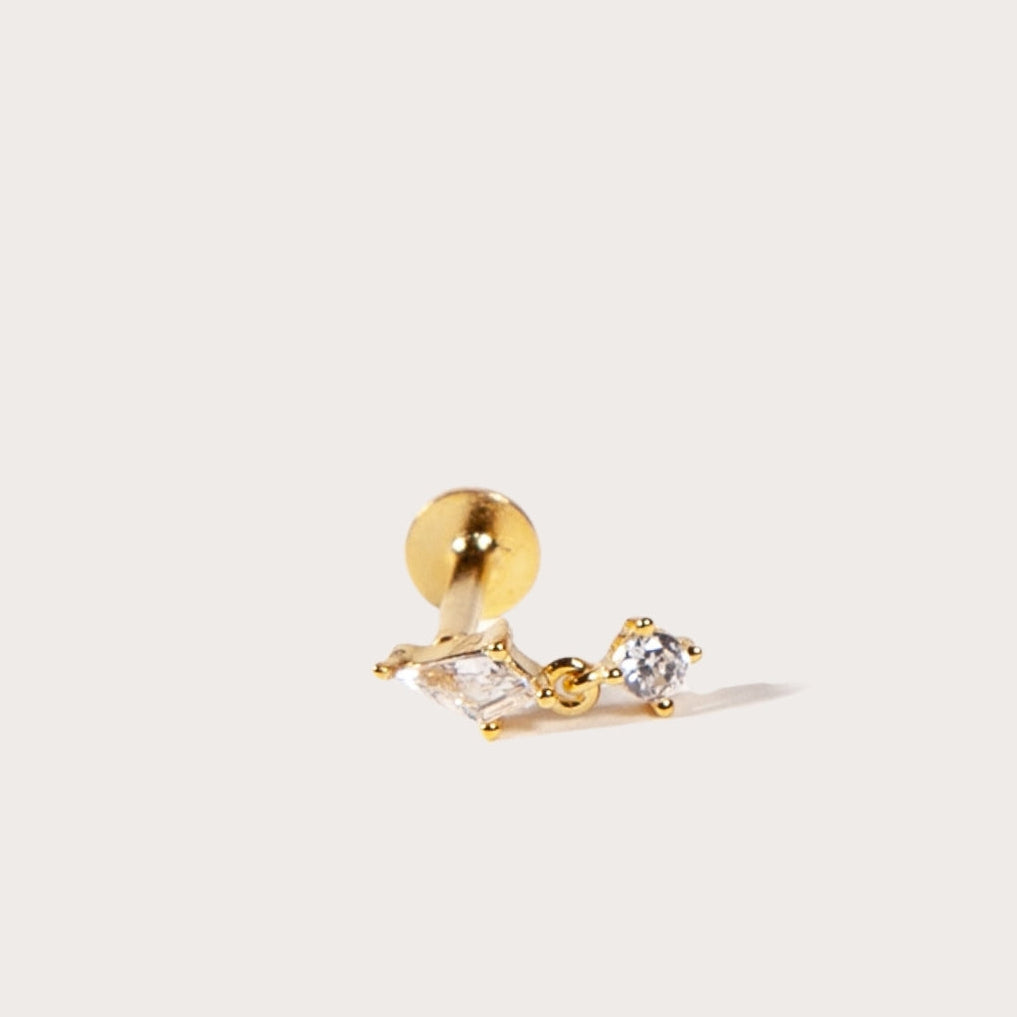 Gold earring with a small round CZ on a white background