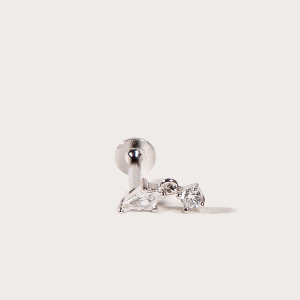 Silver earring with clear CZ on a light gray background