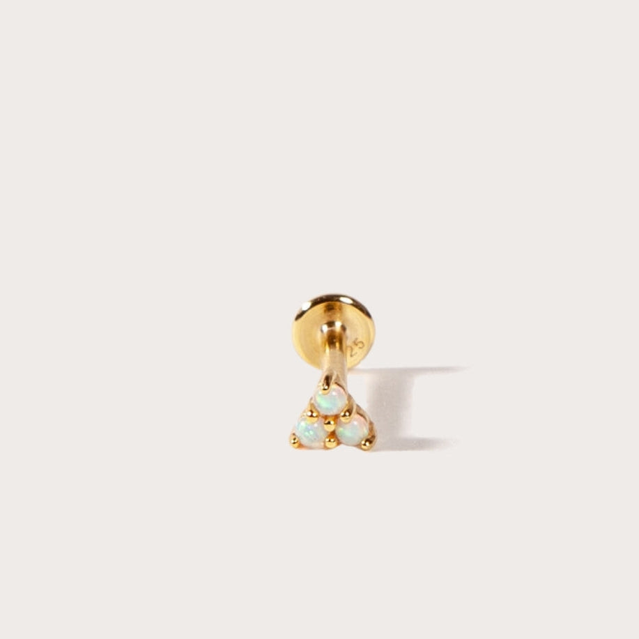 Gold earring with a small triangle stones on a white background