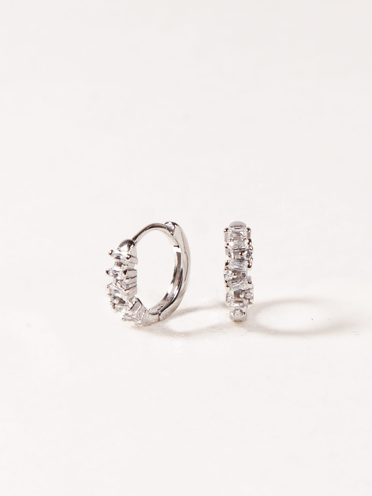 Pair of silver hoop earrings on a white background