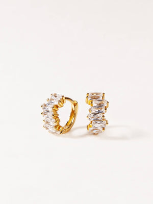 Gold hoop earrings with clear gemstones on a white background