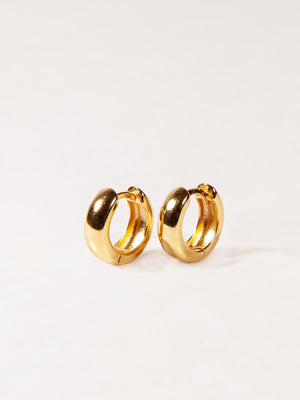Pair of gold Chunky hoop earrings on a white background