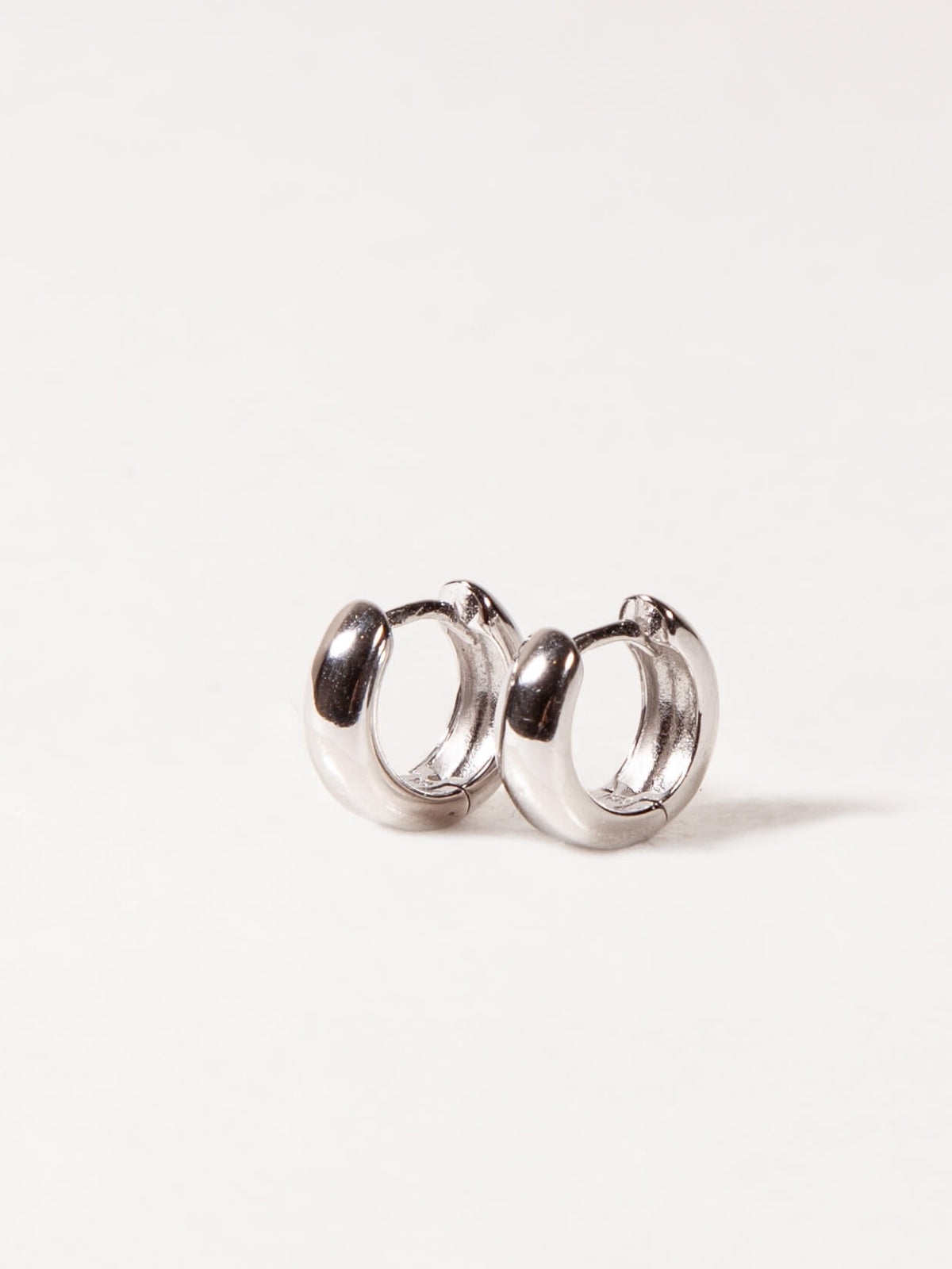 Pair of silver hoop earrings on a white background