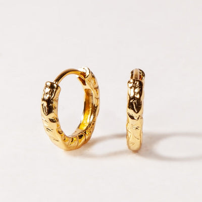 Gold hoop earrings on a white background