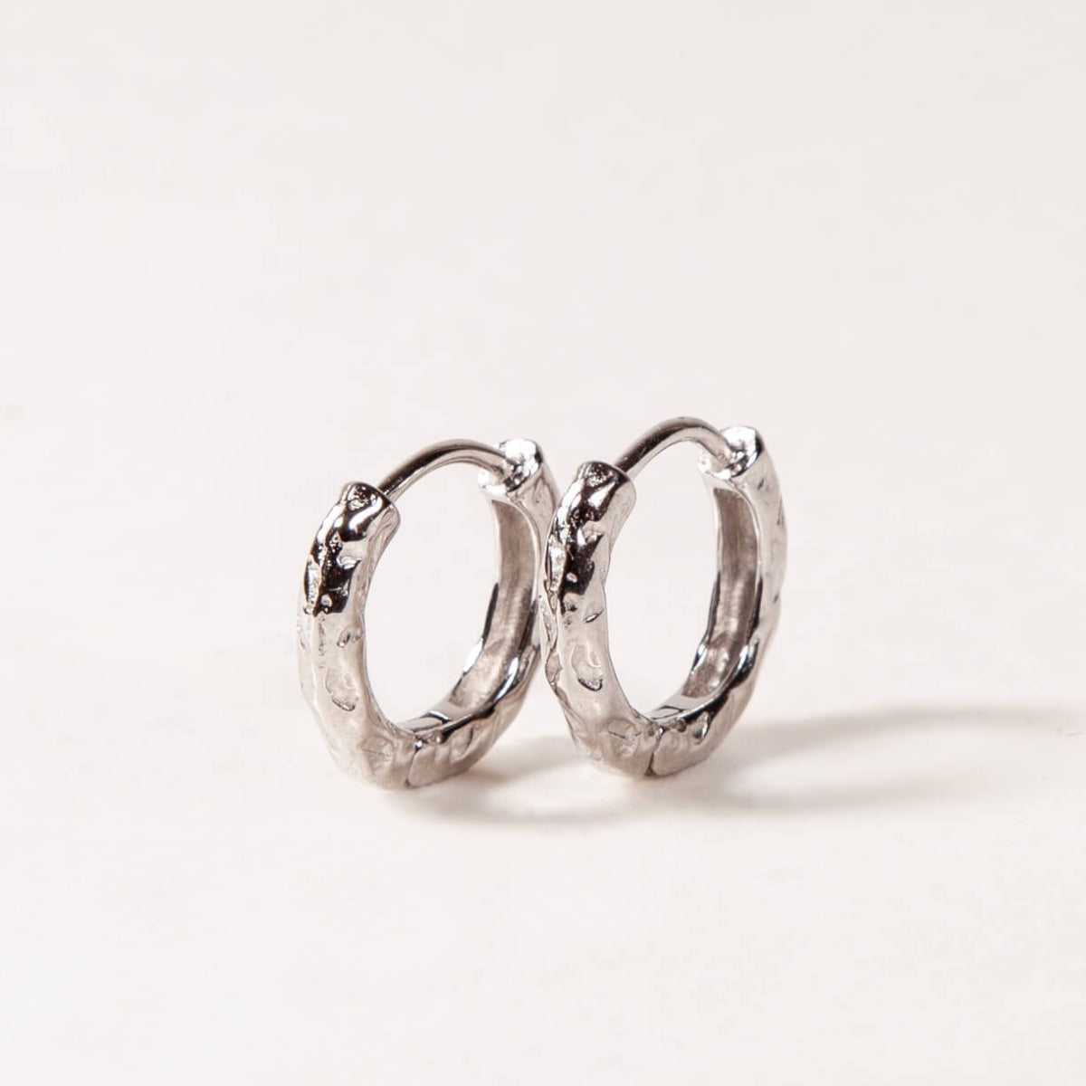 Pair of silver hoop earrings on a light background