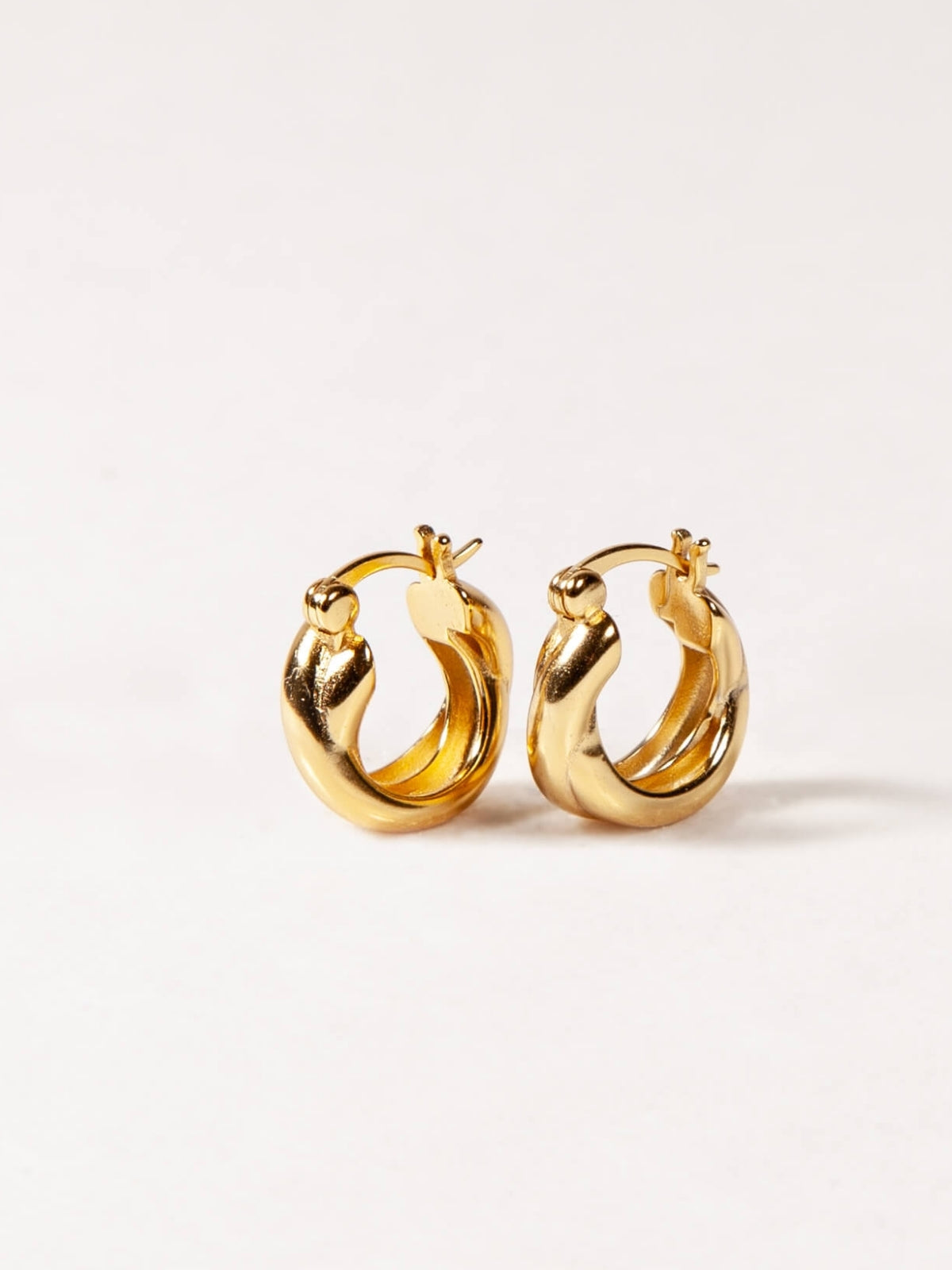 Gold hoop earrings on a white background