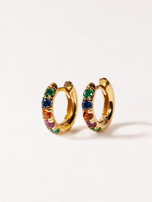 Gold hoop earrings with colorful gemstones on a white background