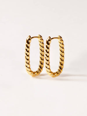 Pair of gold twisted U hoop earrings on a white background