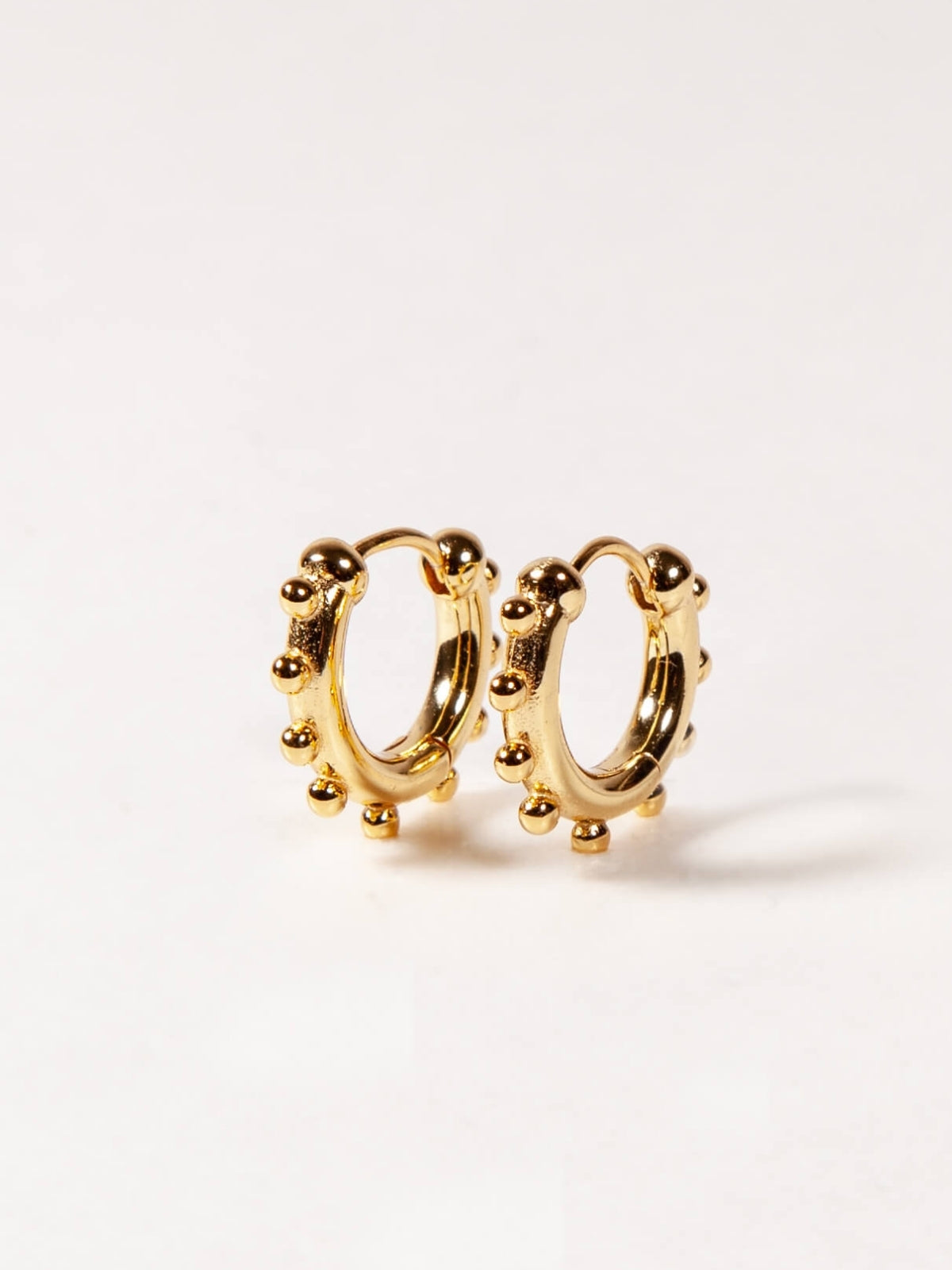 Gold hoop earrings on a white background